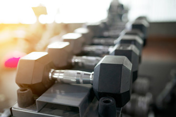 Close up black dumbbell set in sport fitness center , Weight Training concept.