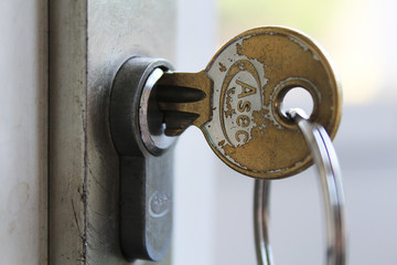 metal key in front door lock 