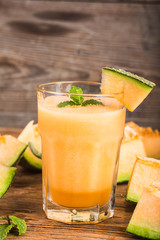 The juice of melon with mint in a glass jar on the table.Hami melon