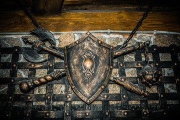 Shield axe and sword hanging on the wall