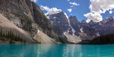 Fototapeta na wymiar Beautiful turquoise waters of Lake Moraine, embraced by the Valley of the Ten Peaks in Banff National Park, Alberta, Canada