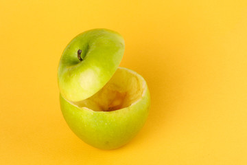 Healthy Green Cut Apple floating top slice juice drink idea concept on yellow background