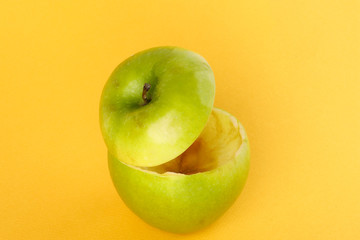Healthy Green Cut Apple floating top slice juice drink idea concept on yellow background