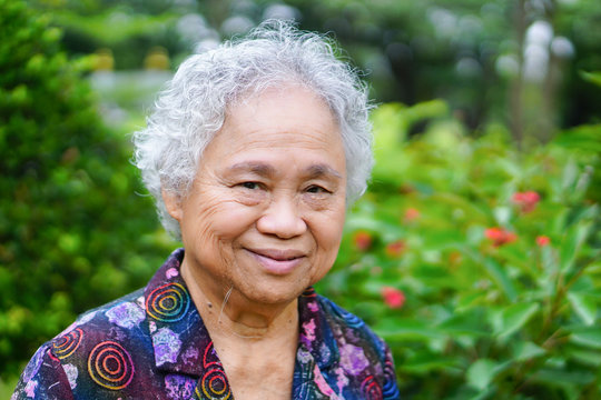 Asian Senior Or Elderly Old Lady Woman Smile Bright Face With Strong Health While Walking At Park In Holiday 