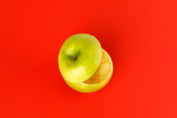Healthy Green Cut Apple floating top slice juice drink idea concept on red background