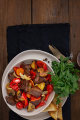 Dinner plate with fried meat and vegetables top view