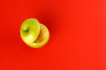 Healthy Green Cut Apple floating top slice juice drink idea concept on red background