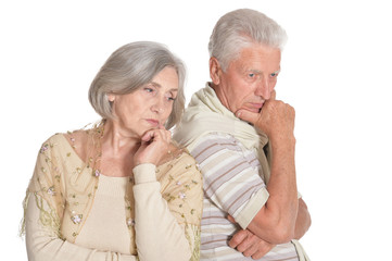 Portrait of sad senior couple on white background
