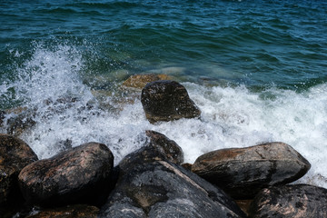 Surf and rocks in blue-green water