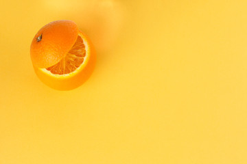 Healthy Orange Cut floating top slice juice drink idea concept on yellow background