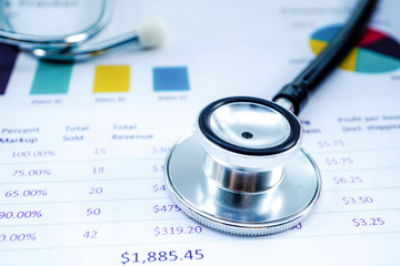 Stethoscope, Charts and Graphs spreadsheet paper, Finance, Account, Statistics, Investment, Analytic research data economy spreadsheet and Business company concept.
