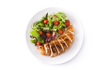 Grilled chicken breast with vegetables on a plate isolated on white background. Top view