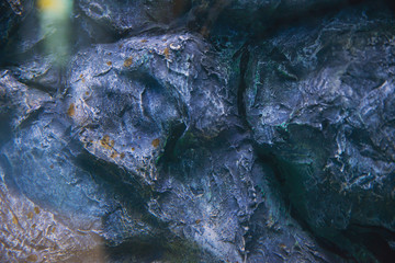 texture of wild stone with moss and vegetation, abstract texture of natural solid minerals