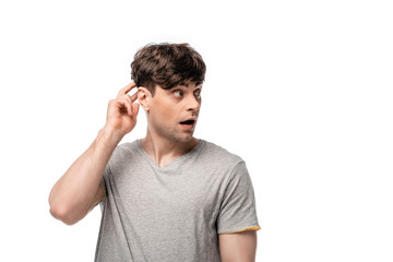 discouraged young man looking away and touching head with hand isolated on white