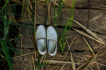white moccasins on wooden floor