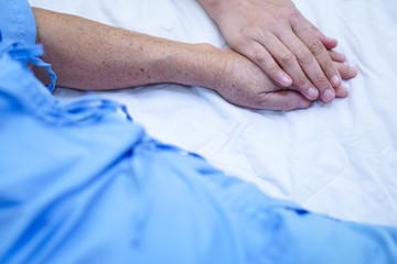 Touching hands Asian senior or elderly old lady woman patient with love, care, helping, encourage and empathy at nursing hospital ward : healthy strong medical concept 