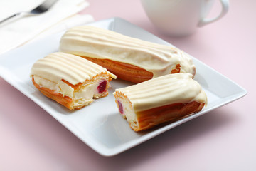 Eclairs Filled with Bavarian Cream and White Chocolate Glaze