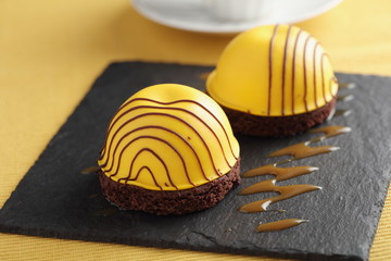 Mango marshmallow on chocolate disk with chocolate icing 