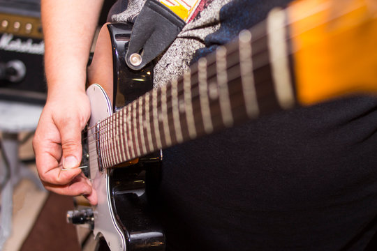 electric guitar close up in the hands of a guitarist