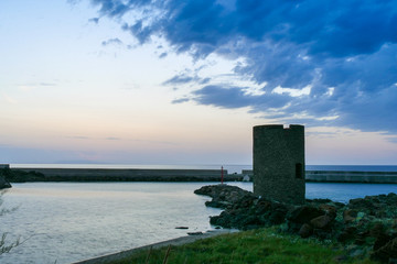 old building, light house. sunset at the shore