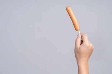 Hand holding sausage
