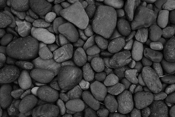 black stone background, closeup pebble beach stone