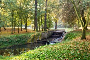 River bed with weir in autumn season
