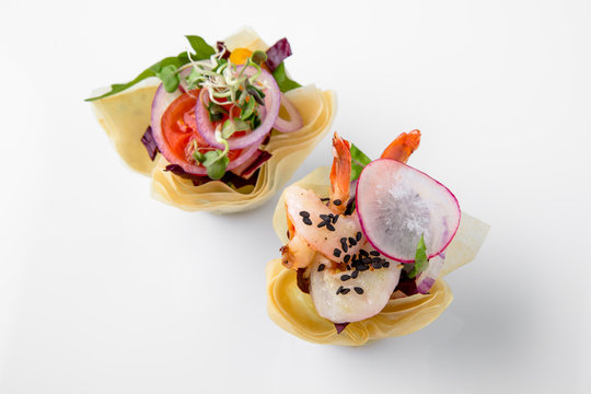 Canape tartlet with shrimp and vegetables. Beautifully decorated catering banquet menu. Food snacks and appetizers for buffet. Isolated on white background