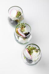 Olives in a glass. Beautifully decorated catering banquet menu. Food snacks and appetizers for buffet. Isolated on white background
