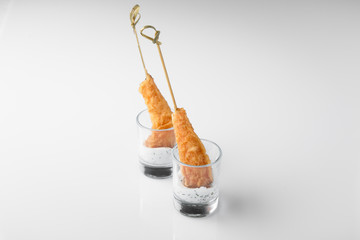 Shrimp in batter on a skewer with sauce. Beautifully decorated catering banquet menu. Food snacks and appetizers for buffet. Isolated on white background