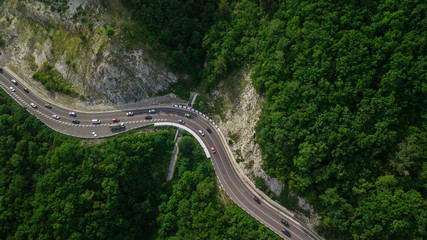 Drones Eye View - winding road from the high mountain pass in Sochi, Russia. Great road trip trough...