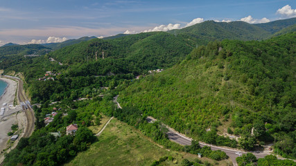 Fototapeta na wymiar Aerial view from drone - winding road from the high mountain pass in Sochi, Russia.