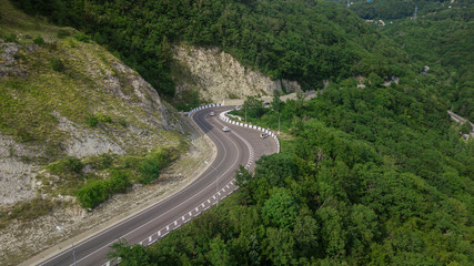 Aerial view from drone - winding road from the high mountain pass in Sochi, Russia.
