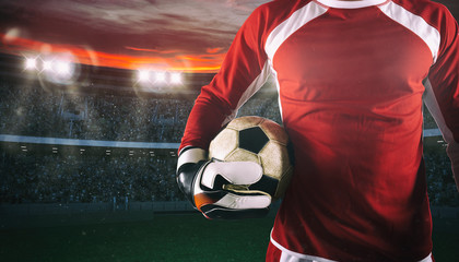 Goalkeeper ready to play with ball in his hands at the stadium