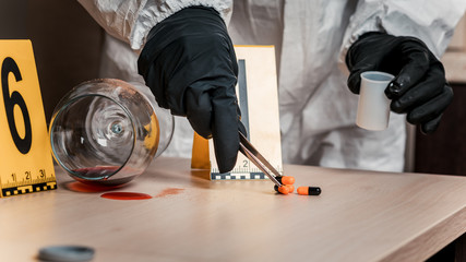 Forensic expert collects evidence at the crime scene. Poisoning