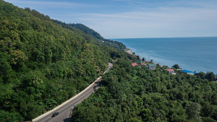 Aerial view - curvy road of mountain road to Sochi, Russia. Great road trip trough the dense woods.