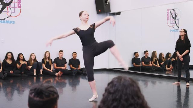 Female Ballet Student At Performing Arts School Performs For Class And Teacher In Dance Studio