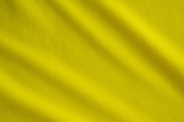 Yellow color sports clothing fabric jersey football shirt texture top view close up