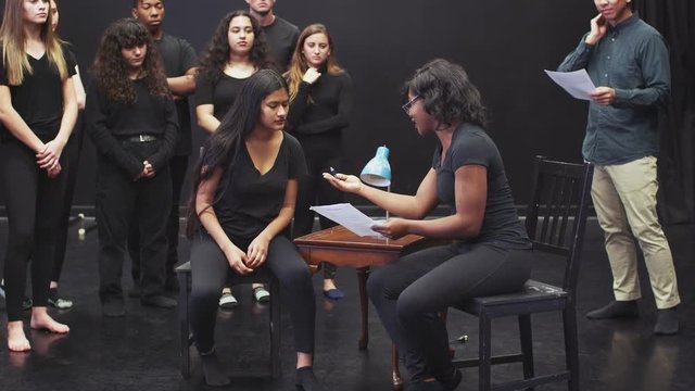 Teacher With Drama Students At Performing Arts School In Studio Improvisation Class