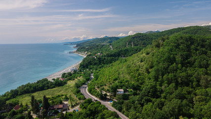 Birds Eye View - winding road from the high mountain pass in Sochi, Russia. Great road trip trough the dense woods.