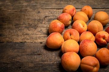 fresh apricots in a basket on a wooden table