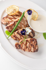Grilled fish fillet: dorada, cod, halibut, pollock, tilapia. Seafood. Banquet festive dishes. Fine dining restaurant menu. White background.