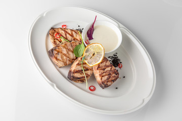 Grilled fish fillet: dorada, cod, halibut, pollock, tilapia. Seafood. Banquet festive dishes. Fine dining restaurant menu. White background.