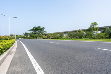 Fototapeta premium empty asphalt road with city skyline