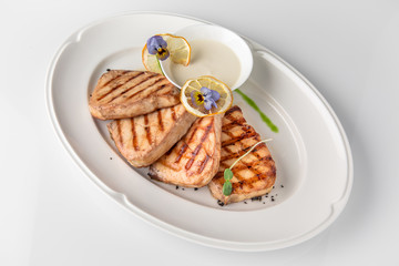Grilled salmon fish fillet (red fish). Seafood. Banquet festive dishes. Fine dining restaurant menu. White background.