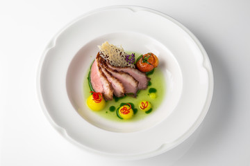 Sliced pork carving in sauce with mashed potatoes and grilled vegetables. Banquet festive dishes. Fine dining restaurant menu. White background. 