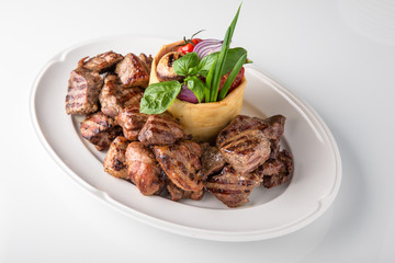 Skewers of pork, beef with vegetables and mushrooms. Grilled meat. Banquet festive dishes. Fine dining restaurant menu. White background. 