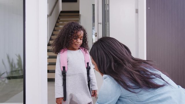 Mother Giving Daughter High Five As She Leaves For School