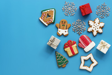 Christmas background, gingerbread and gift boxes on a blue background.View from above, flat lay,...