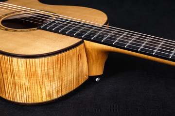 Fototapeta premium Tuning pegs on wooden machine head of six strings acoustic guitar neck on black background